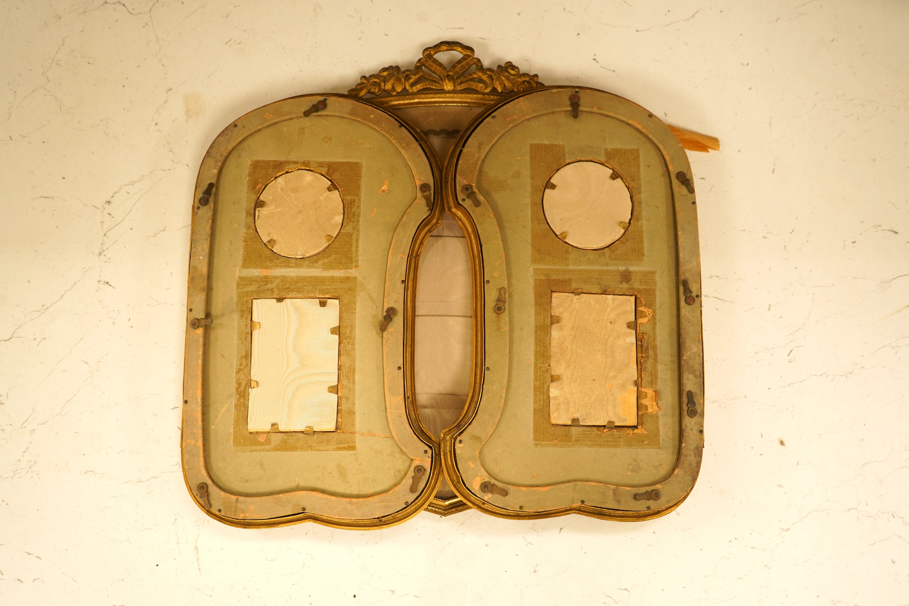 An Edwardian gilt framed triptych photo frame with watered silk backing, overall 72cm wide